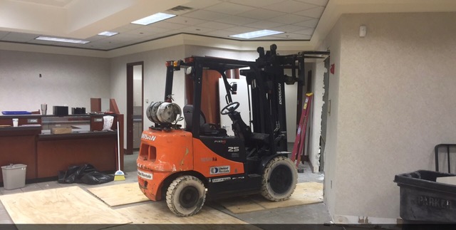 Professional banking equipment installation showing vault doors, safe deposit boxes, and security systems